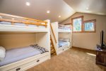The expansive upstairs bonus room with 2 sets of custom built bunks
